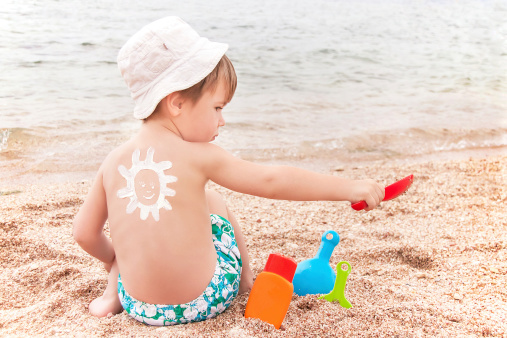 Child sitting alone on sea shore