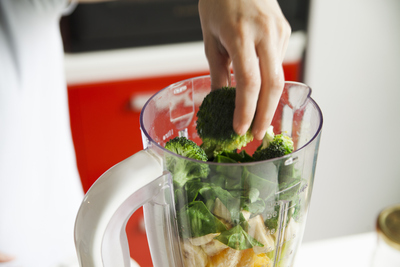 Lady making smoothie to reduce Eczema